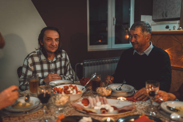 istock People sitting at the table during a family dinner at home 1042851646