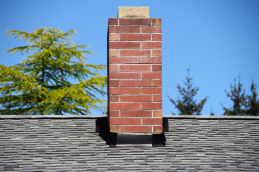 Chimney on a residential building with an overcast sky