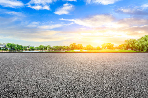 istock Empty asphalt road and green forest with colorful clouds 1042868074