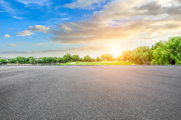 istock Empty asphalt road and green forest with colorful clouds 1042873264