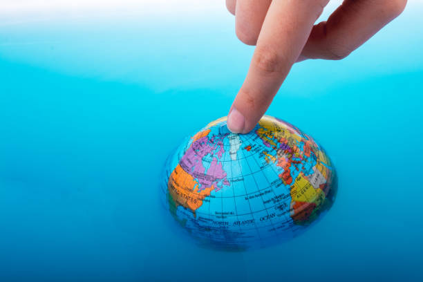 istock Little globe  with finger on top floating 1042876330