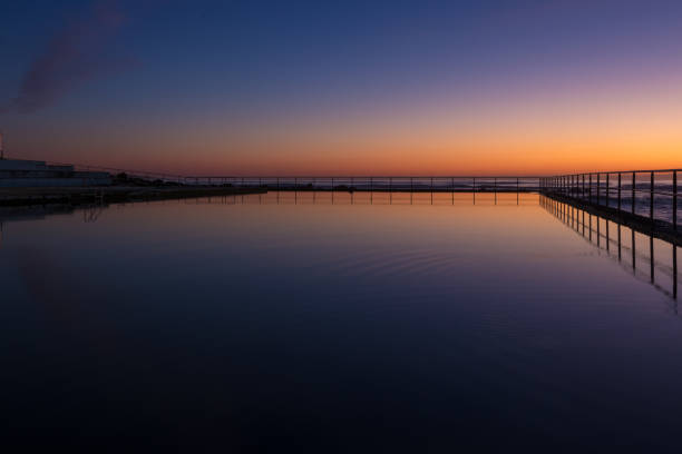 istock Dawn sky reflection in a seaside coastal pool 1042888084