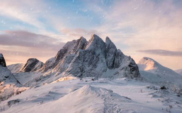Majestic mountain range with snowfall at sunrise morning Panorama Majestic mountain range with snowfall at sunrise morning on Segla island, Senja, Norway senja island photos stock pictures, royalty-free photos & images