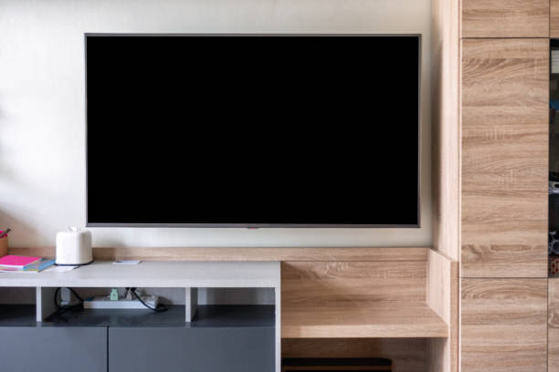 istock LED Flat Screen TV hanging on wall 1042891828