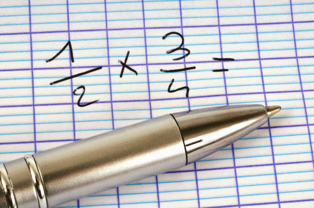 Engineer making calculations for his work with calculator, pencil and compasses
