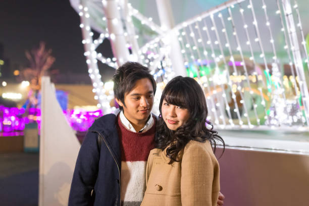 istock High school couple walking in Christmas lights 1042901234