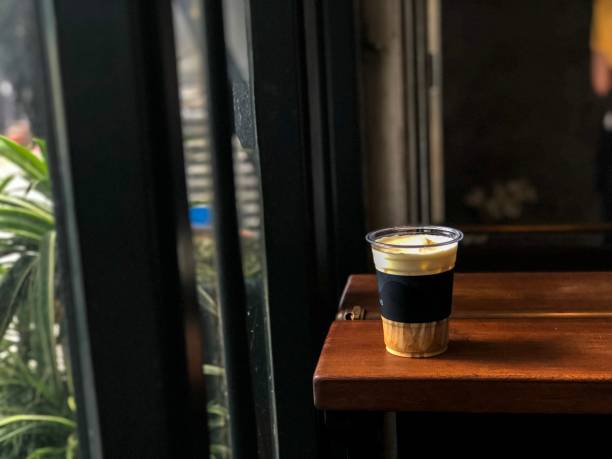 Iced coffee with milk on table