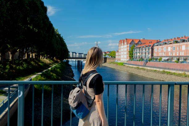 istock Young girl stay on a bridge with Bremen on background 1042913568