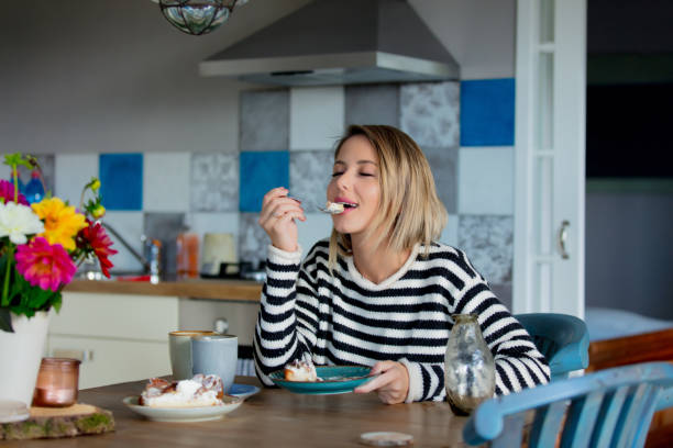 istock girl at kitchen with cake in breakfast time. 1042917522
