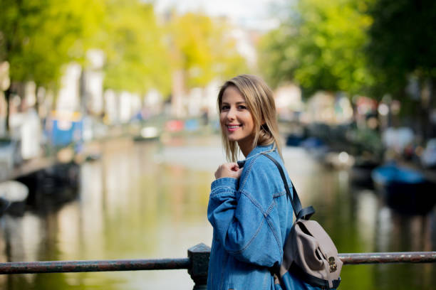 istock girl with backpack in Amsterdam 1042917566