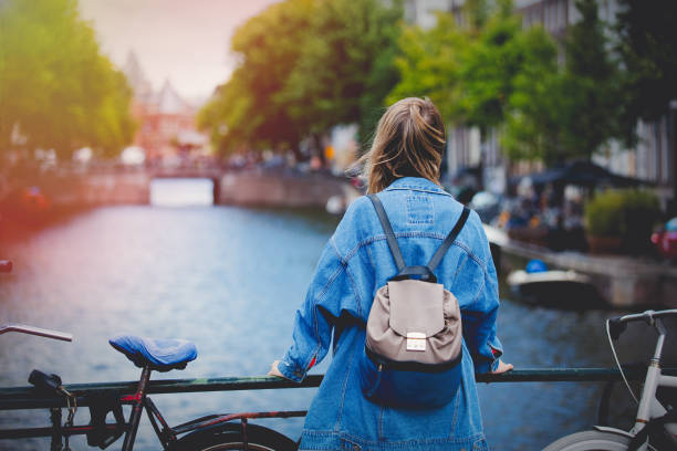 istock girl with backpack in Amsterdam, Fall season 1042917626