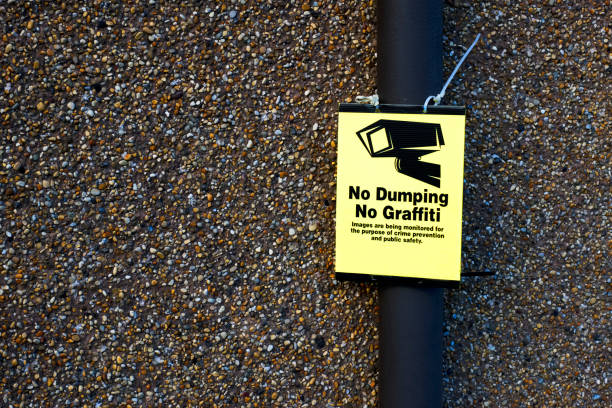 Security cameras with cyber warning on digital background. Red warning triangle featuring an exclamation mark and a digital background of binary code