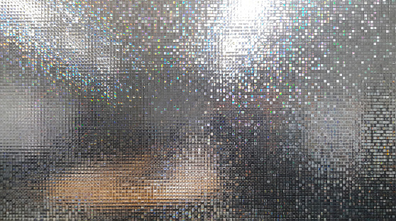 abstract colorful light of mosaic and bokeh on glass door or window at blur on secrets meeting room for art wallpaper and texture or party background
