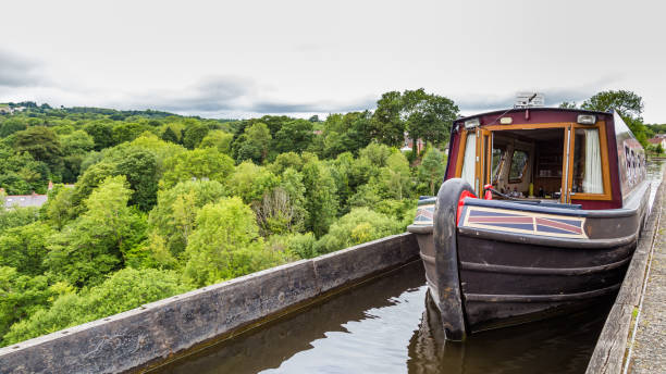 Blue narrowboat moored on a stretch of the Grand Union Canal by the town of Radford Semele near Leamington Spa, Warwickshire, English West Midlands.