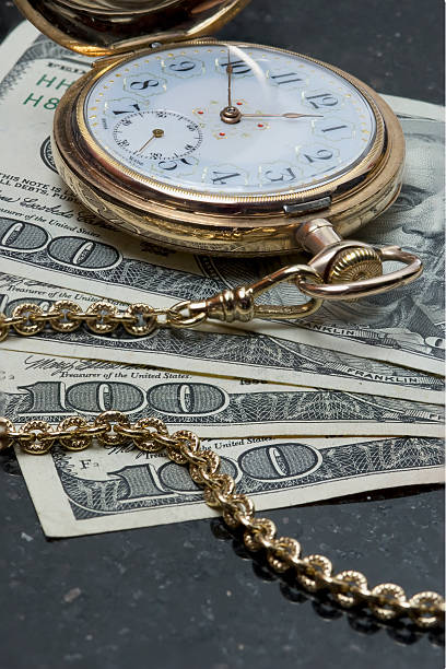 istock Pocketwatch atop US $100 bils 104292438