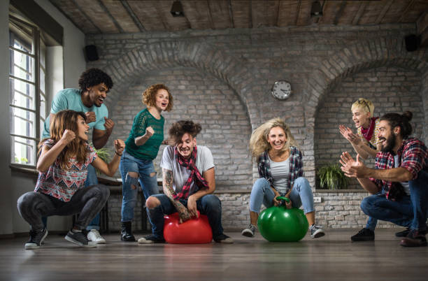 istock Cheering during space hopper game at casual office! 1042924522