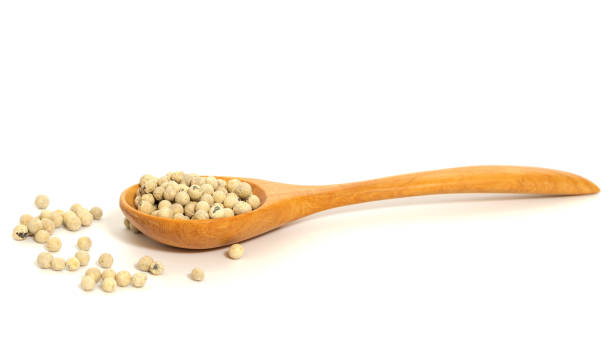 istock Peppercorn with wooden spoon on white background. Composition isolated over the white background. 1042931130