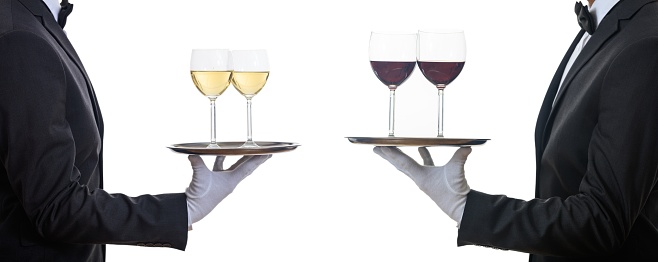 Waiters holding trays with red and white wine glasses