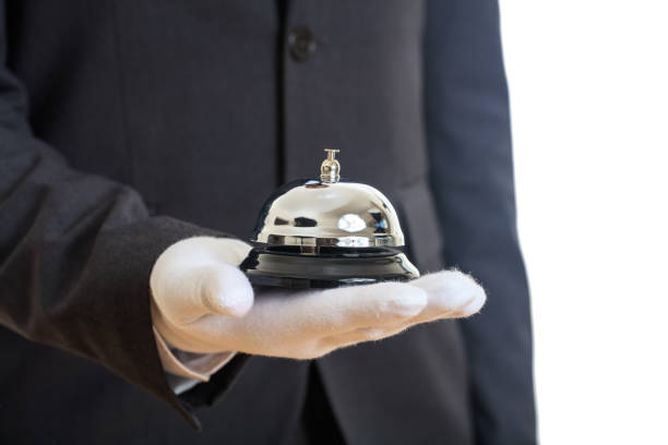 istock Butler service bell in a gloved hand 1042933414