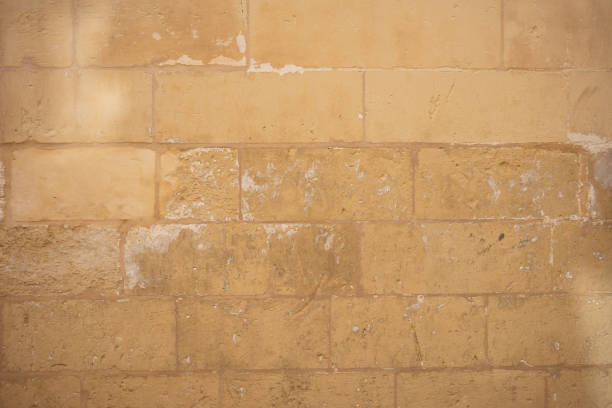 istock Traditional weathered stone wall background in Malta 1042936056