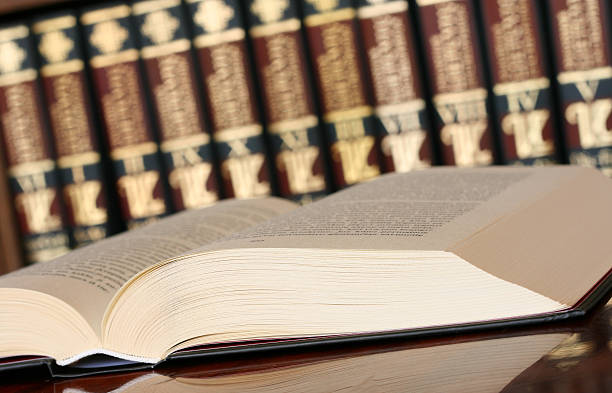 istock An open book in front of many books representing knowledge 104293624