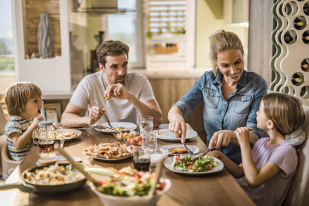 istock Happy family having fun while talking during lunch time in dining room. 1042936878