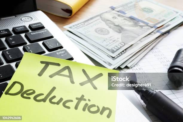 Tax Deduction Written On A Memo Stick Stock Photo - Download Image Now - Tax, Business, Credit Card