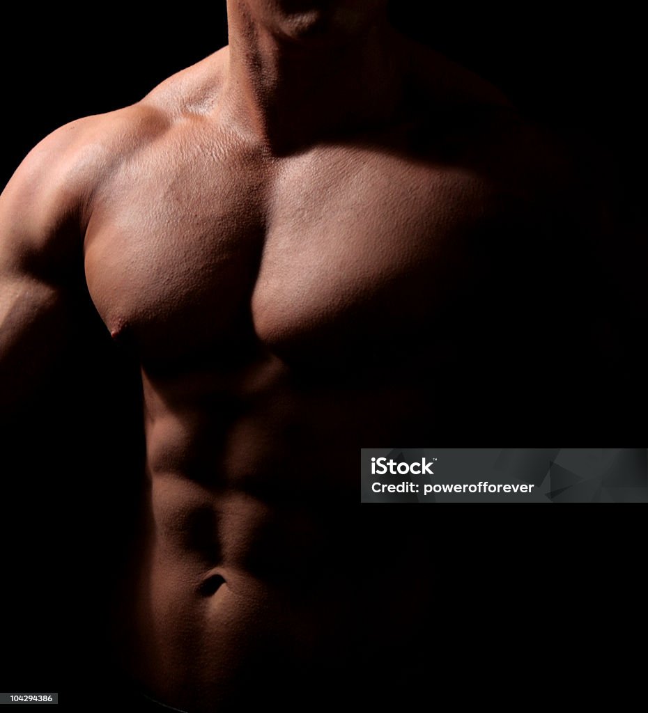 Muscled Body Low key image of a muscular torso Men Stock Photo