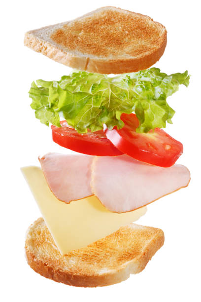istock Flying ingredients for sandwich with bacon isolated on white background 1042948840