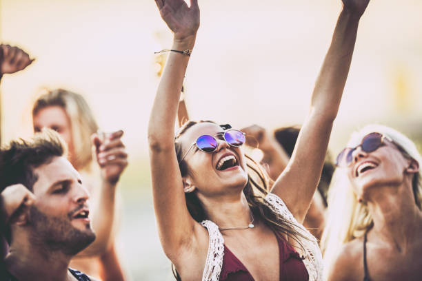istock Young happy woman having fun while singing on a party in summer day. 1042951252