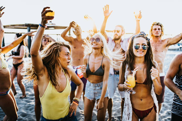 istock Young cheerful people having fun on a beach party. 1042957446
