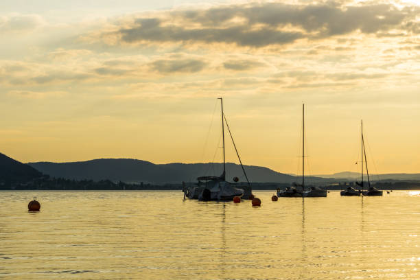 istock Boats anchoring on silent lake water in magic hour 1042958454