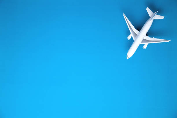 istock Airplane on blue background. Travel concept 1042964422