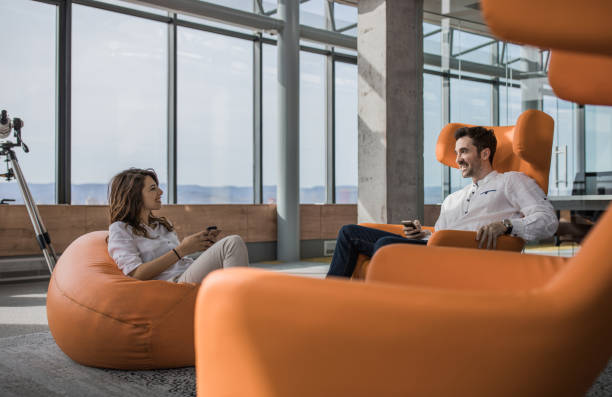 istock Young happy colleagues talking to each other on a break. 1042964742