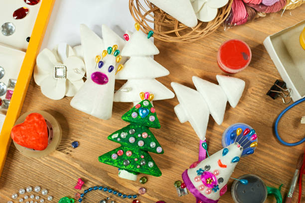 istock Handmade decorations for new year and other holidays. Artwork workplace with creative accessories. 1042964828