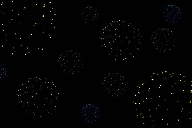 Holiday lights fireworks in the black sky at night, abstract background