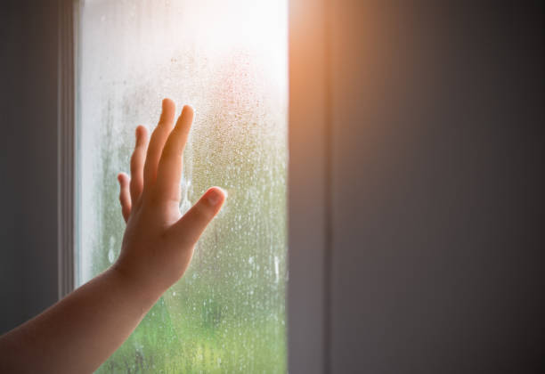istock Hand child with fogged on the window. 1042968338