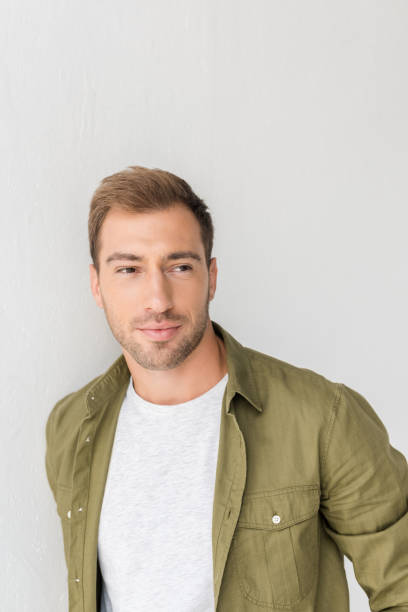 istock happy man looking away against white wall 1042968494