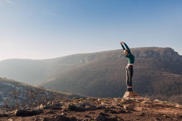 istock Young fit woman exercising on a mountain top 1042971786