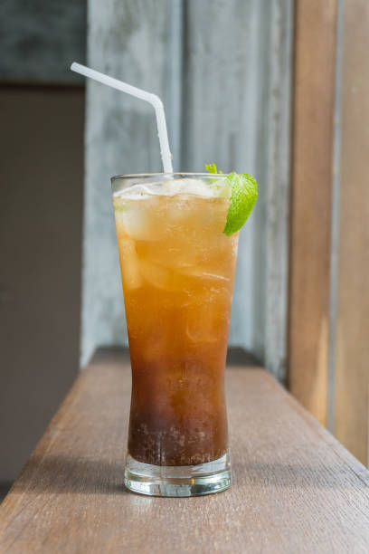 istock Close up ice lemon tea on wood table ,selective focus blur background 1042982254