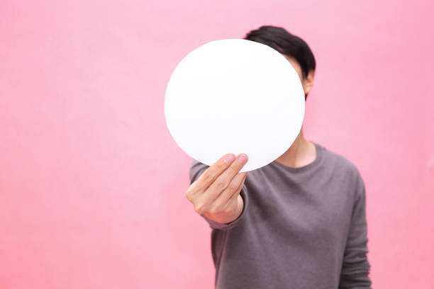 istock Young man showing and presenting an empty blank rounded mockup paper - with copy space to insert any text. 1042982568