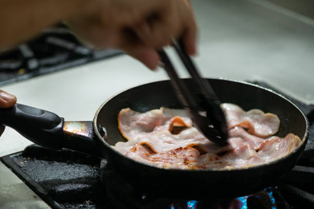 istock Bacon cooked in frying pan. 1042982854