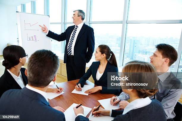A Business Meeting Using Charts And Diagrams Stock Photo - Download Image Now - Active Seniors, Adult, Business