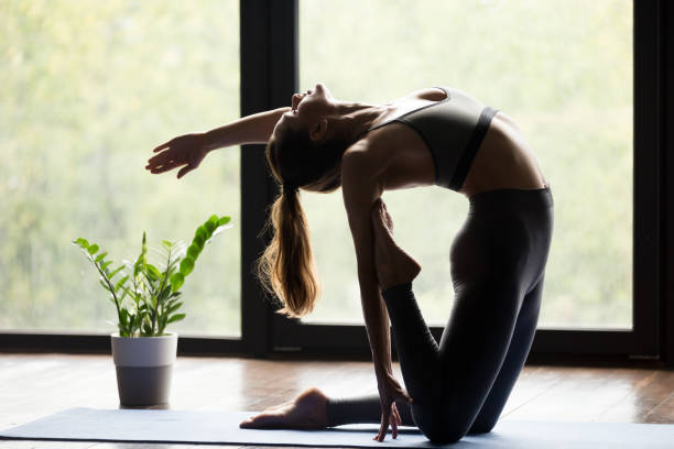 istock Young sporty woman doing Ustrasana backbend exercise 1042985090