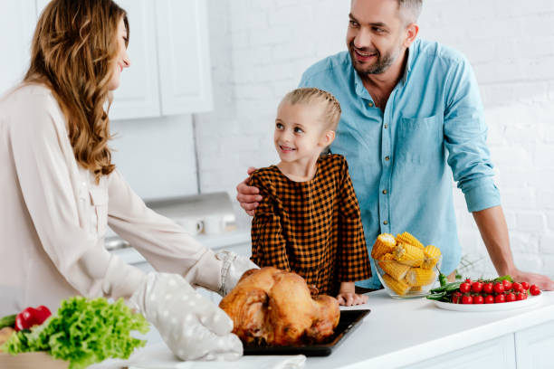 istock happy little child preparing thanksgiving dinner with parents 1042990044
