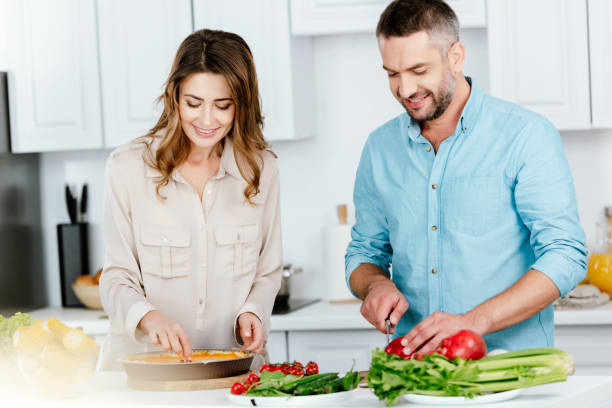 istock beautiful couple making pie together at kitchen 1042990090