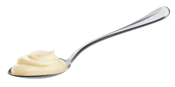 Photo of Sour cream in spoon isolated on white background