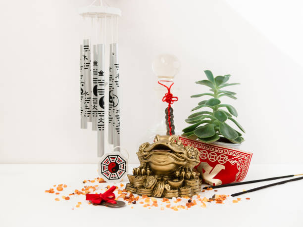 Feng-shui for home Feng Shui art of harmony of space. Various baubles symbolizing feng shui: Wind music, Chinese coins, pyramid, pagoda, frog, lilac napkin, aroma, salty water. Cozy house. Succulent. chinese frog stock pictures, royalty-free photos & images