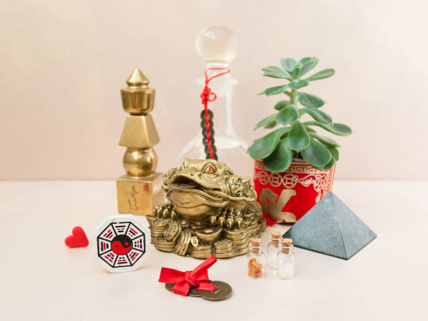Feng-shui for home Feng Shui art of harmony of space. Various baubles symbolizing feng shui: Wind music, Chinese coins, pyramid, pagoda, frog, lilac napkin, aroma, salty water. Cozy house. Succulent. chinese frog stock pictures, royalty-free photos & images