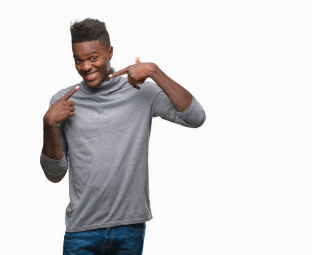 istock Young african american man over isolated background smiling confident showing and pointing with fingers teeth and mouth. Health concept. 1043002814